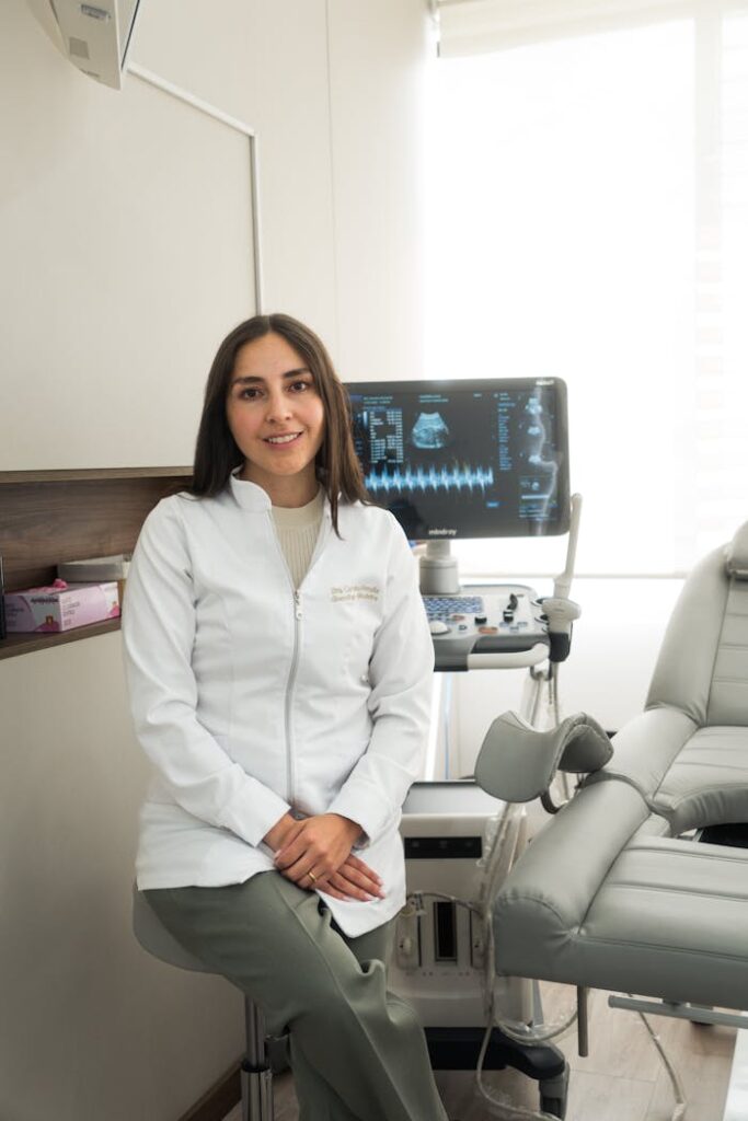 Confident female dentist in a modern clinic with dental equipment.